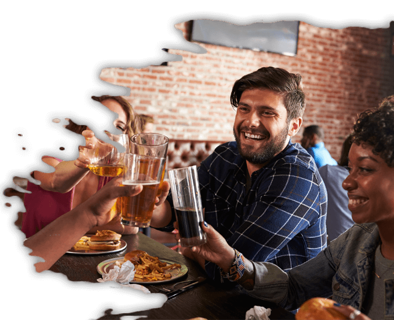 Young adults having a drink at the axe throwing facility.